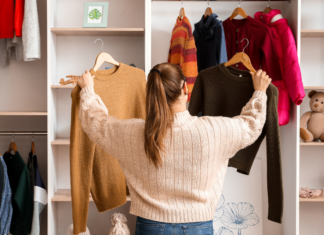 A women looking through clothes in her wardrobe.