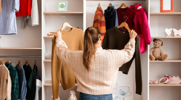 8 Wardrobe Must-Haves from Westchester Mompreneurs A women looking through clothes in her wardrobe.