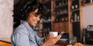 Westchester County Mom Top 10 Posts of 2019 A woman reading on her phone while drinking coffee.