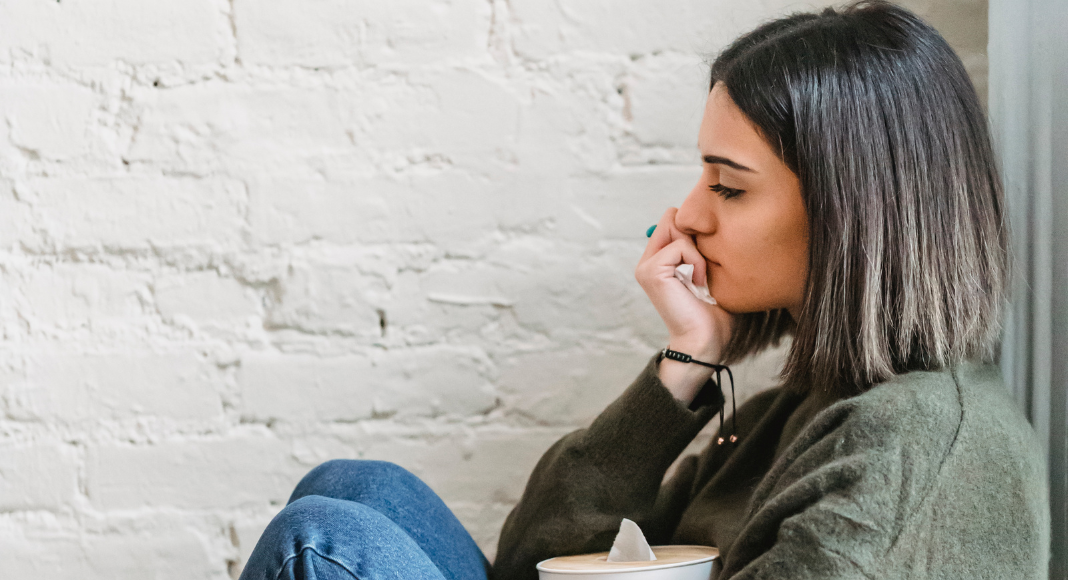A woman sitting in sadness.