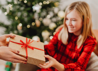 Maintaining a Minimalist Christmas Giving a gift to a girl on Christmas.