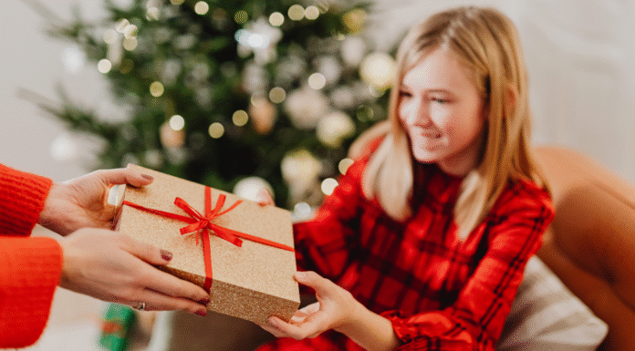 Giving a gift to a girl on Christmas.
