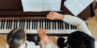 Making music on the piano with music lessons.