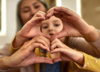 Be Thankful All Year Round Making hearts with your hands.