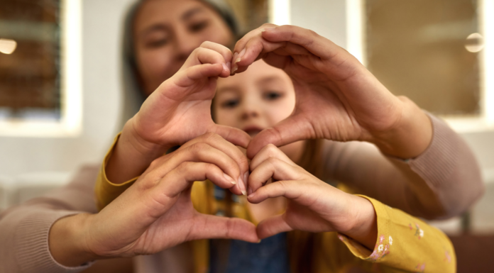 Making hearts with your hands.