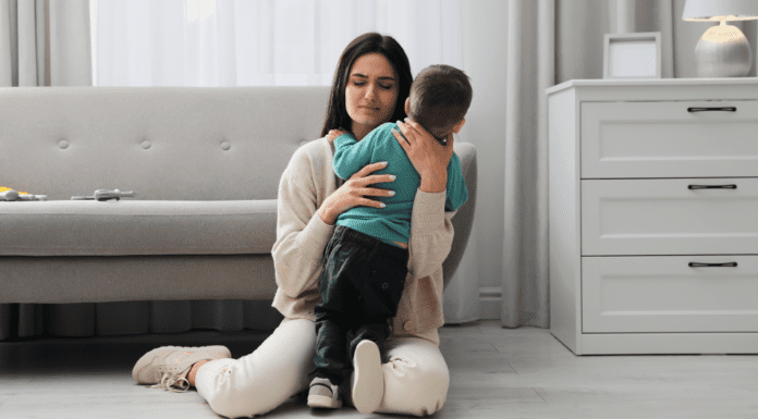 A mom holding her anxious son.