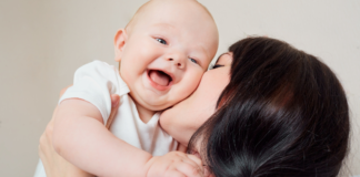 10 Ways I have Irrevocably Been Changed by Motherhood A mom kissing her baby.