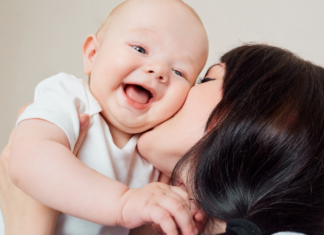 10 Ways I have Irrevocably Been Changed by Motherhood A mom kissing her baby.