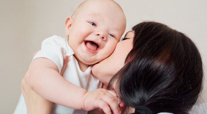10 Ways I have Irrevocably Been Changed by Motherhood A mom kissing her baby.