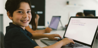 A boy coding on the computer.