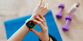 A woman adjusting her fitness watch.