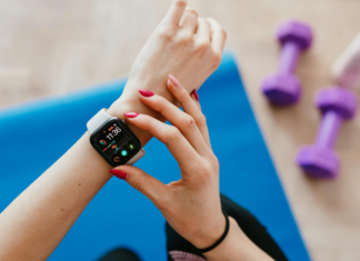 2020 Fitness, Health & Wellness Guide A woman adjusting her fitness watch.