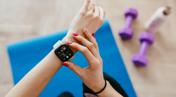A woman adjusting her fitness watch.