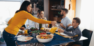 A mother feeding her family at the table.