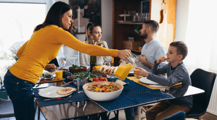 A Mother Always Makes Room at the Table A mother feeding her family at the table.