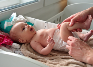 Baby Hacks for New Moms Changing a baby's diaper.