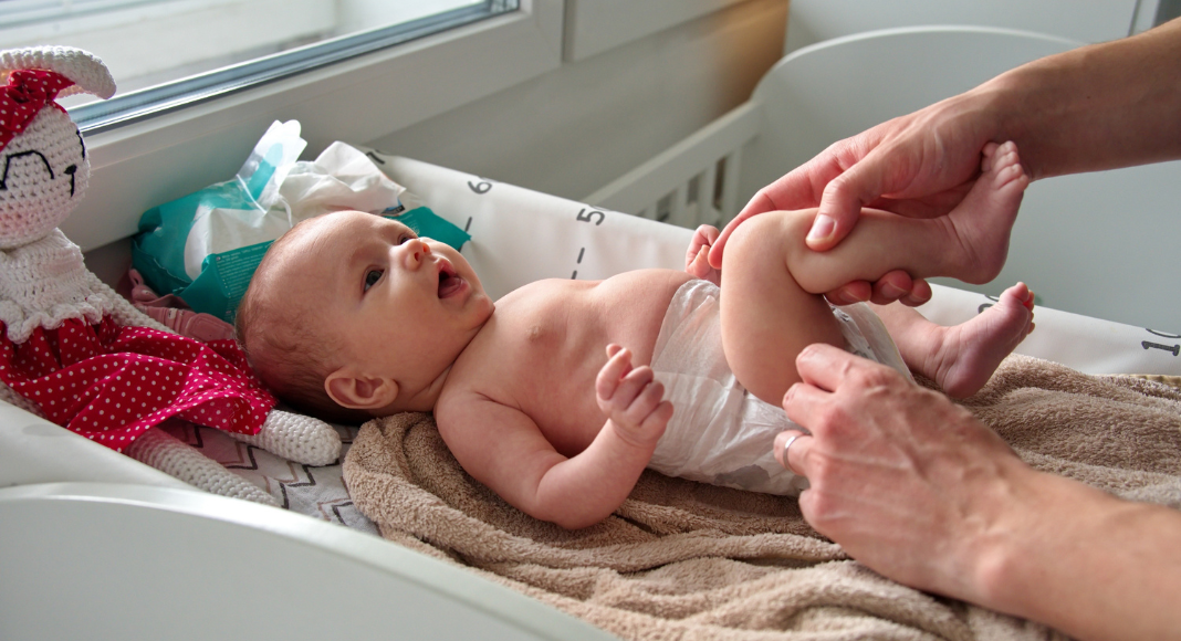 Changing a baby's diaper.