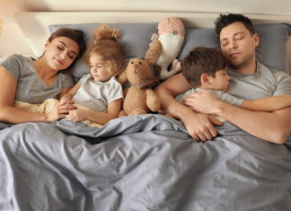 A family sleeping in the primary bedroom.