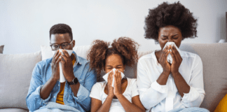 Combating Winter Colds & Fevers A sick family blowing their noses.