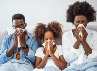 A sick family blowing their noses.