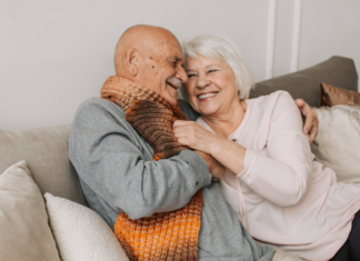 Life Is All Too Fleeting An older couple cuddling on the couch.