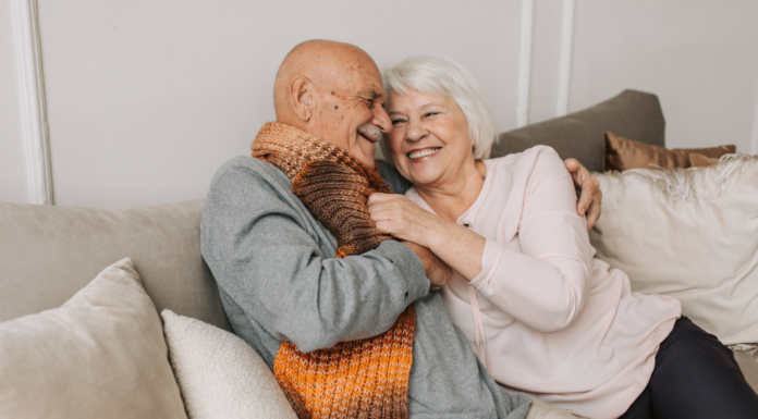 Life Is All Too Fleeting An older couple cuddling on the couch.