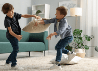 Brothers fighting with pillows.