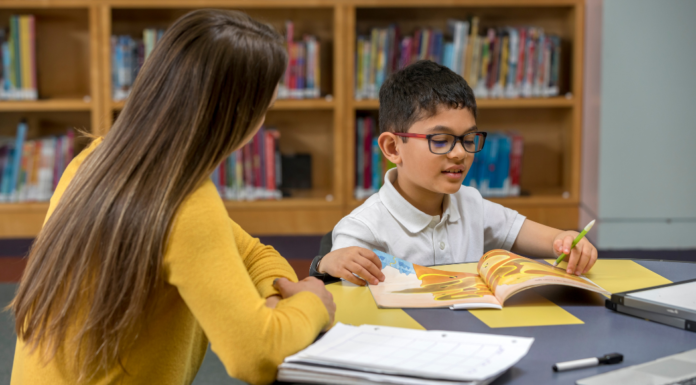Confidence and Success with WhizKidz Tutoring A boy being tutored in the library.