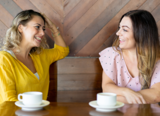 Is Talking With Friends About Money Taboo? Two women talking while drinking coffee.