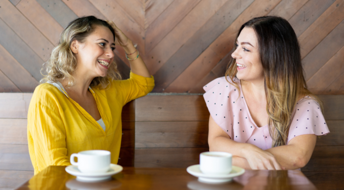 Is Talking With Friends About Money Taboo? Two women talking while drinking coffee.