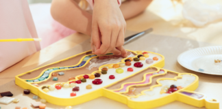 A child's hand designing art work.