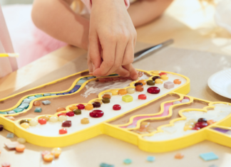 A child's hand designing art work.
