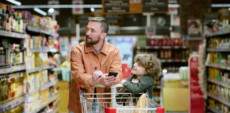 Fun and Stress-Free Grocery Shopping with Kids A dad with his son grocery shopping.