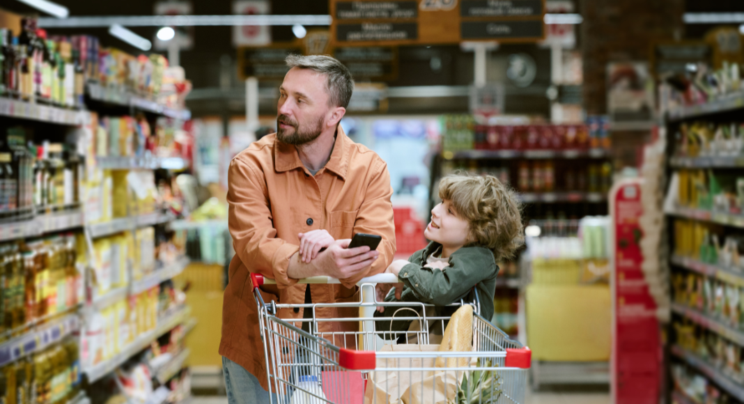 A dad with his son grocery shopping. 