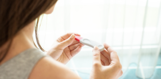 The Power of Planning Parenthood A woman holding a pregnancy test.
