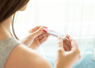 The Power of Planning Parenthood A woman holding a pregnancy test.