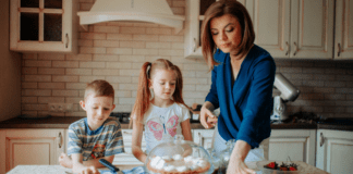 5 Sanity-Saving Habits for Moms Who Never Stop A mom and her kids looking at desserts on the counter.