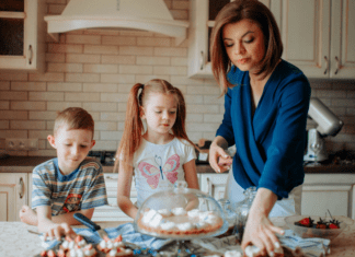 5 Sanity-Saving Habits for Moms Who Never Stop A mom and her kids looking at desserts on the counter.