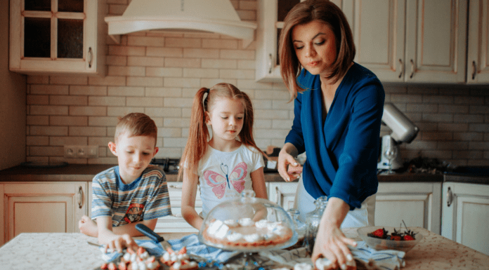 5 Sanity-Saving Habits for Moms Who Never Stop A mom and her kids looking at desserts on the counter.