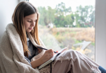 A girl writing in a journal.