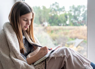 A girl writing in a journal.