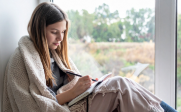 A girl writing in a journal.