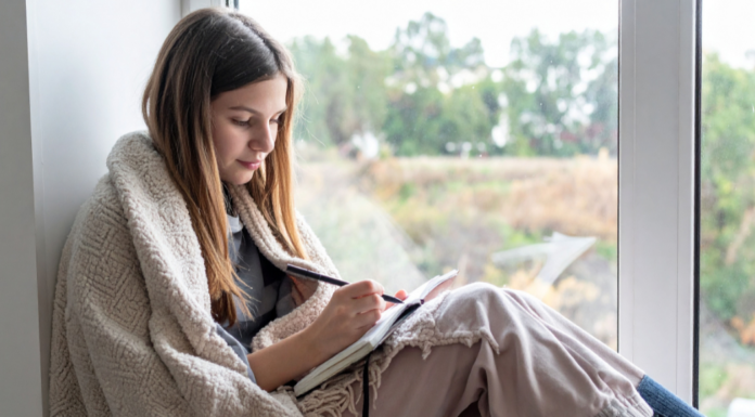 A girl writing in a journal.