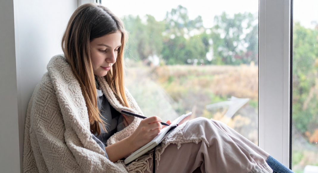 A girl writing in a journal.