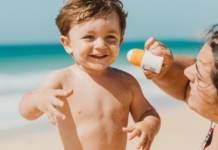 A mom trying to apply sunscreen.