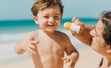 A mom trying to apply sunscreen.