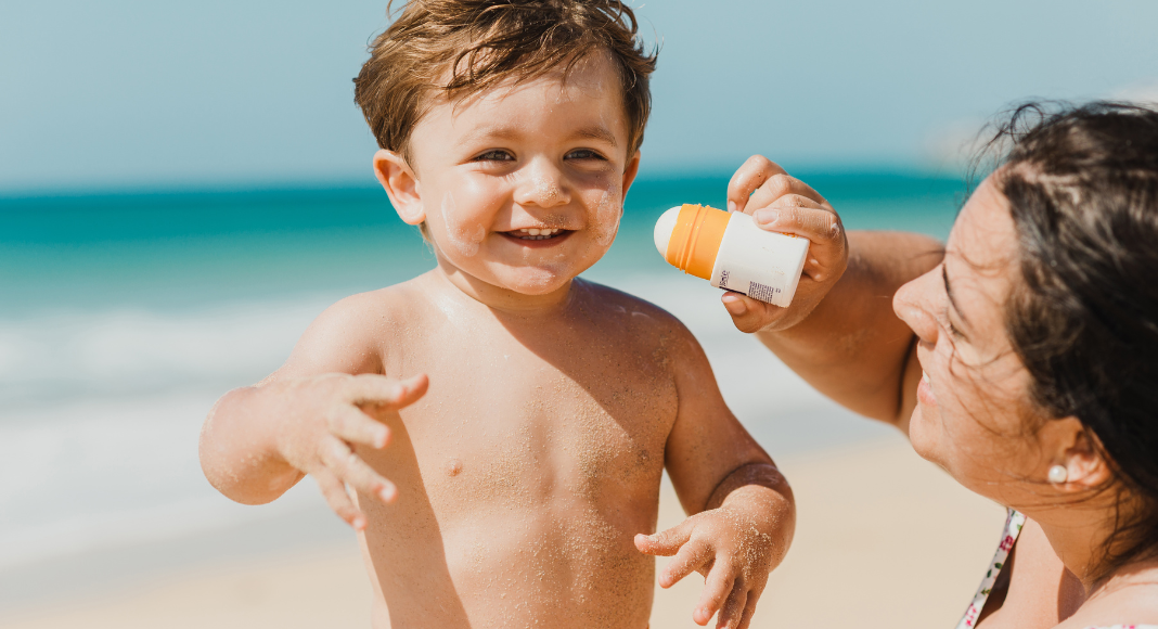 A mom trying to apply sunscreen.