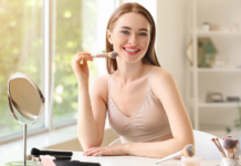 Tired of Looking Tired: 7 Things Every Mom Needs In Her Bag of Tricks! A woman applying makeup.