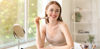 Tired of Looking Tired: 7 Things Every Mom Needs In Her Bag of Tricks! A woman applying makeup.