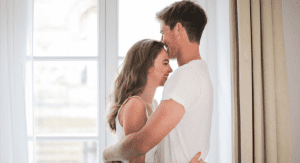 Man and woman embracing.
